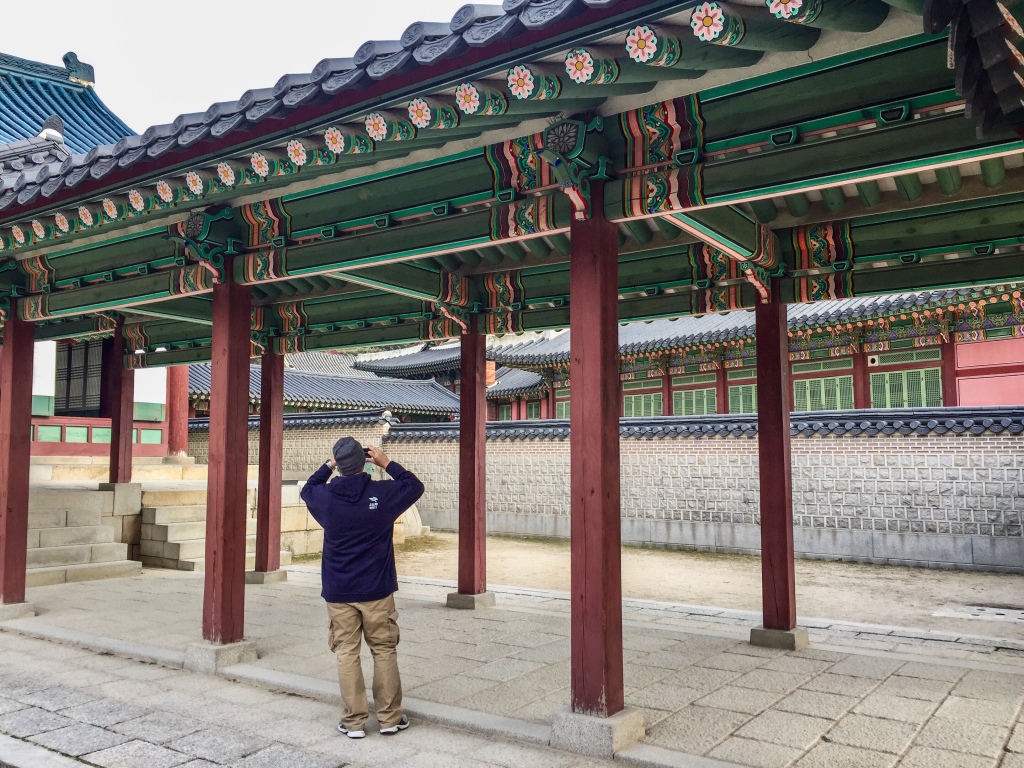 Another tourist taking a photo in a palace in Seoul, South Korea